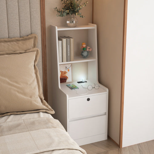 White nightstand with shelves and drawers next to a bed with beige pillows.
