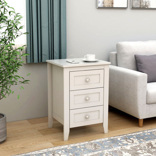 White side table with drawers in a living room setting