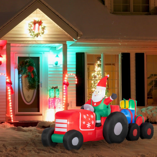 Inflatable Santa Claus on a red tractor in front of a house decorated for Christmas.