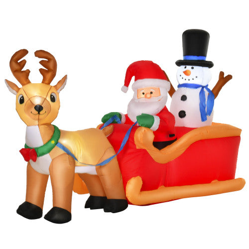 Inflatable Christmas scene with reindeer, Santa Claus, and snowman on a sleigh.