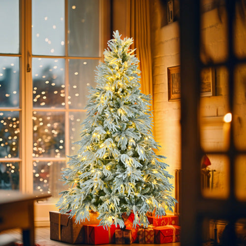 Decorated Christmas tree with lights in a room with a window and presents underneath.