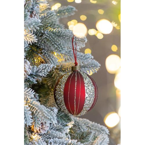 Red and gold Christmas ornament on a decorated tree with blurred lights in the background