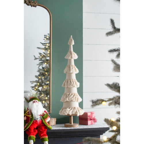 Decorative Christmas tree with ruffled design on a mantel, surrounded by festive decorations.
