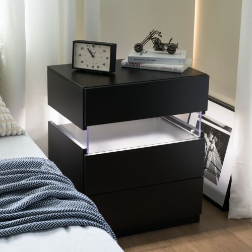 Black nightstand with LED lighting on a bedroom floor.